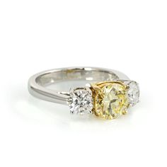 three stone engagement ring with yellow and white diamonds