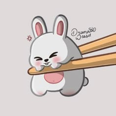 a cartoon bunny holding two chopsticks in it's mouth