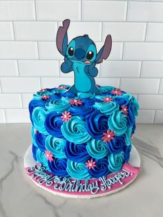 a birthday cake with blue frosting and an image of stitcher from the movie stitcher