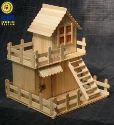 a wooden model of a house with stairs leading up to the roof