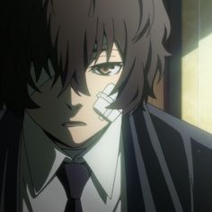 an anime character with black hair wearing a suit and tie, looking at the camera