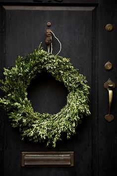 a wreath is hanging on the front door