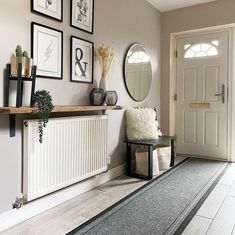 a living room with pictures on the wall and a radiator in front of it