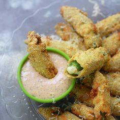 some fried food on a plate with dipping sauce