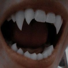 an open mouth with white teeth is shown