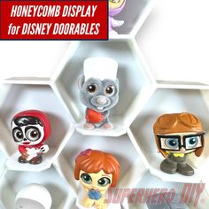 there are many toy figurines in the hexagonal display for disney dolls