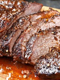 sliced steak on a cutting board with seasoning sprinkled around the top and sides