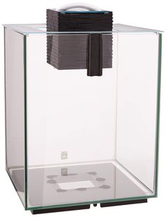 a glass box with some sort of electronic device in the bottom half and an object on top of it