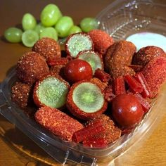 a plastic container filled with different types of food next to grapes and yogurt