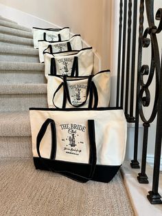 the bride tote bags are lined up on the stairs