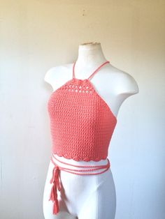 a mannequin wearing a red top with tassels