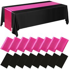 the table cloth is black, pink and white with different color bands on each side