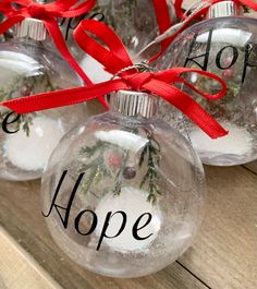 three glass ornaments with the words hope and hope on them