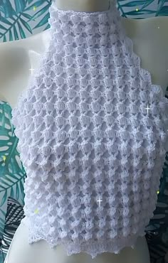 a white crocheted scarf on top of a mannequin