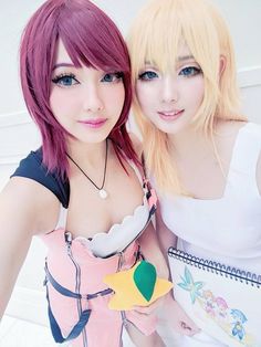 two young women with pink hair posing for the camera