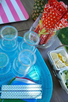 there are many cups and bowls on the table