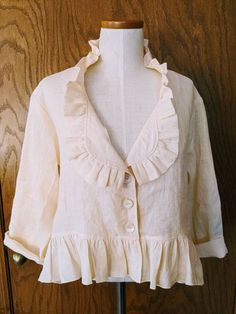 a white blouse with ruffles on it