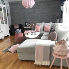 a living room filled with furniture and pink accents