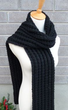 "This beautiful hand knitted scarf is made with Super Bulky and Soft Wool Blend Yarn (50% wool, 50% acrylic). Classic ribbed pattern, it looks the same on both sides. The scarf can be worn in multiple ways. Amazing color for the fall/winter season. It goes with everything. The color may appear slightly different on different monitors. Measures: 75\" (190 cm) long x 8\" (20 cm) wide. From a smoke-free home. Care instructions: Hand wash in cool water and dry flat." Hand Knitted Acrylic Yarn Scarf For Cold Weather, Hand Knitted Acrylic Yarn Scarves For Cold Weather, Winter Hand Knitted Black Knitting Pattern, Knitted Acrylic Yarn Scarves For Cold Weather, Knitted Yarn Scarves For Cold Weather, Black Crochet Scarves For Winter, Handmade Black Scarf For Fall, Black Yarn Knitting Pattern, Handmade Black Scarves For Fall