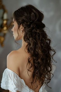 a woman with long hair wearing a white dress looking at herself in the mirror and holding her hand on her hip