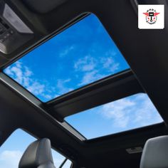 the sunroof in a car with blue sky and clouds