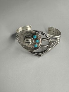 Sterling silver cowboy hat and rope cuff, set with three small round turquoise. Solid, Sturdy and Substantial! One size fits most. Western Turquoise Bracelet With Concho, Western Style Turquoise Bracelet With Concho, Western Turquoise Bracelets With Concho, Adjustable Turquoise Western Bracelet, Adjustable Turquoise Cuff Bracelet With Concho, Western Sterling Silver Bracelets, Western Sterling Silver Cuff Bracelet, Adjustable Western Sterling Silver Cuff Bracelet, Western Style Sterling Silver Bracelets