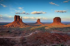 the desert is full of red rocks and green trees