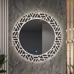 a round mirror mounted to the side of a wall next to a potted plant