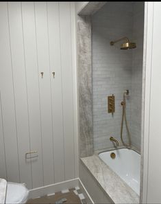 a bathroom with a bathtub and shower head