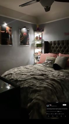 a large bed sitting in a bedroom next to two pictures on the wall