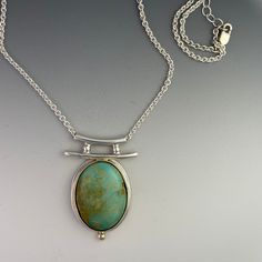 "Turquoise Pendant set with a 14k Gold bezel on Sterling Silver. Accented with a 14k Gold Ball.  The Turquoise is Stabilized Thunder Bird Turquoise.  The turquoise is approximately 18mm by 22mm oval.  This pendant is handmade in my home studio. It is a one of a kind necklace, original design.  The chain is 18\" Sterling Silver." Unique Polished Turquoise Necklace, Elegant Round Turquoise Necklace With Large Pendant, Elegant Oval Turquoise Necklace With Large Pendant, Elegant Turquoise Cabochon Pendant Necklace, Elegant Turquoise Pendant Necklace With Large Stone, Turquoise Cabochon Oval Pendant Jewelry, Elegant Turquoise Necklace With Oval Pendant, Elegant Turquoise Chrysoprase Necklace, Elegant Oval Turquoise Necklace