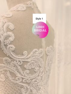 the back of a wedding dress with white lace on it and an advertise