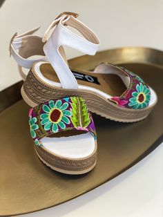 Multicolor embroidery, white leather sandal. Every embroidery is unique and is not identical to any other pair. Colors and embroidery will vary. Embroidery will no be the same as picture shown. Made in Mexico City White Embroidered Closed Toe Sandals, Embroidered Sandals For Summer, Casual Embroidered Open Toe Huarache Sandals, Casual Embroidered Huarache Sandals For Beach, White Closed Toe Sandals For Festivals, Embroidered Casual Huarache Sandals For Beach, Casual Embroidered Huarache Sandals For Spring, White Embroidered Open Toe Sandals, White Closed Toe Huarache Sandals For Vacation