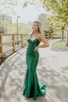 a woman in a green dress posing for the camera