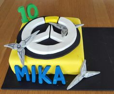 a birthday cake with the number 10 on it and two airplanes in front of it