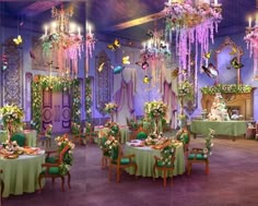 an elaborately decorated dining room with green tablecloths and chandeliers hanging from the ceiling