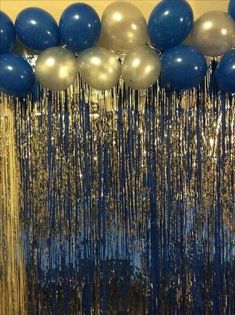 blue and silver balloons hanging from the ceiling