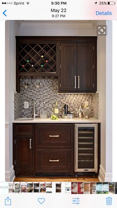 a kitchen with dark wood cabinets and stainless steel appliances in the corner, along with white walls