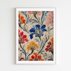 an abstract floral painting hangs on the wall in front of a white frame with blue, orange and red flowers