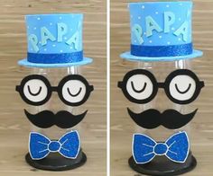 two glasses and a top hat with the word papa on them, both decorated in blue