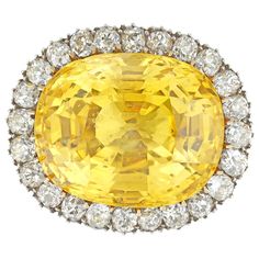 An Important Victorian yellow sapphire and diamond brooch/ring, the natural sapphire weighing 31.58 carats, accompanied by GCS Report stating to be of Sri Lankan origin with no indication of heating, claw-set in yellow gold, surrounded by twenty four old European-cut diamonds estimated to weigh 2.4 carats in total, all set in silver cut-down setting, to yellow gold mount and brooch fitting, circa 1890, with associated gold ring, the head measuring 2.5 x 2.1 cm, finger size L, gross weight 19gram Luxury Heirloom Yellow Sapphire Jewelry, Luxury Victorian Yellow Gold Sapphire Ring, Canary Diamond, Antique Brooches, Diamond Brooch, Gold Ring Sets, European Cut Diamonds, Pretty Rings, Yellow Sapphire