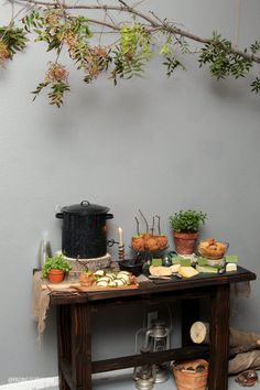 a table topped with lots of food next to a wall