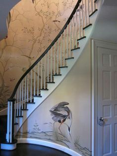 a staircase with birds painted on the wall