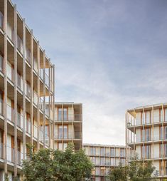 two tall buildings with balconies next to each other