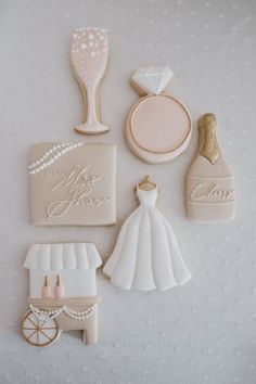 wedding cookies are arranged in the shape of bride and groom's accessories on a table