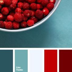 a white bowl filled with raspberries on top of a blue countertop next to red and green color swatches