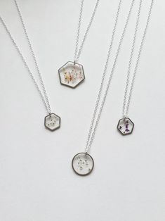 three necklaces with different designs on them