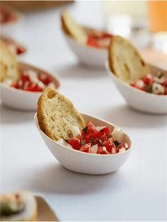 small bowls filled with food sitting on top of a table