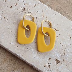 Beautiful polymer clay hoop earrings in organic shapes. You can also wear the golden hoop earrings without the clay charms. So you have two different earrings in one - a plain pair of gold hoop earrings and a colorful pair of larger hoop earrings :) Length: 5cm Width: 2.5cm Hoops: stainless steel I made the earrings from polymer clay. They are very light and comfortable to wear. The manufacturing process begins with shaping, after which the pieces are placed in the oven, where they acquire their Everyday Yellow Polymer Clay Jewelry, Yellow Hoop Earrings For Everyday, Modern Yellow Earrings For Everyday, Modern Yellow Earrings For Everyday Wear, Everyday Yellow Hoop Earrings, Handmade Minimalist Yellow Earrings, Minimalist Handmade Yellow Earrings, Trendy Yellow Earrings For Everyday, Trendy Yellow Everyday Earrings