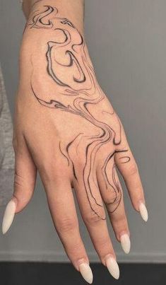 a woman's hand with a tattoo on it